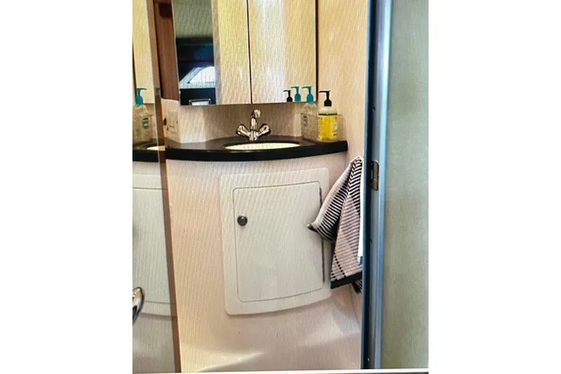 River Time Yacht Photos Pics Bathroom vanity in 2012 Regal 35 Sport Coupe yacht, featuring sink and toiletries.