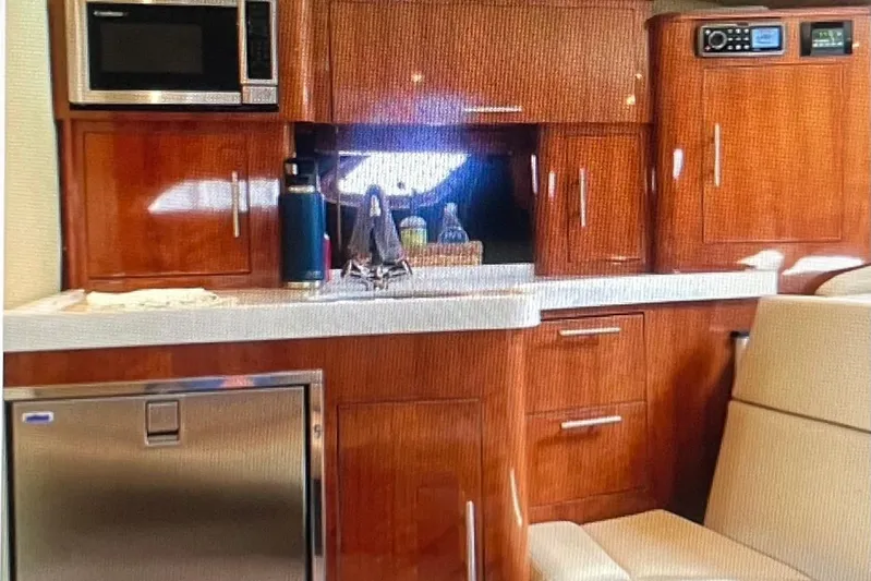 River Time Yacht Photos Pics Luxurious 2012 Regal 35 Sport Coupe interior with wood cabinetry and modern appliances.