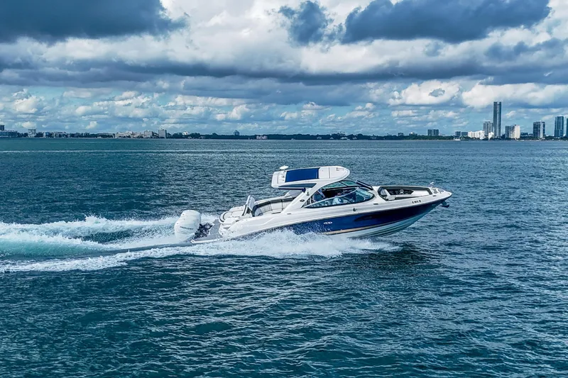 Dock's Knott Inn II Yacht Photos Pics 2018 Sea Ray SLX 350 Outboard cruising on open water under cloudy skies.