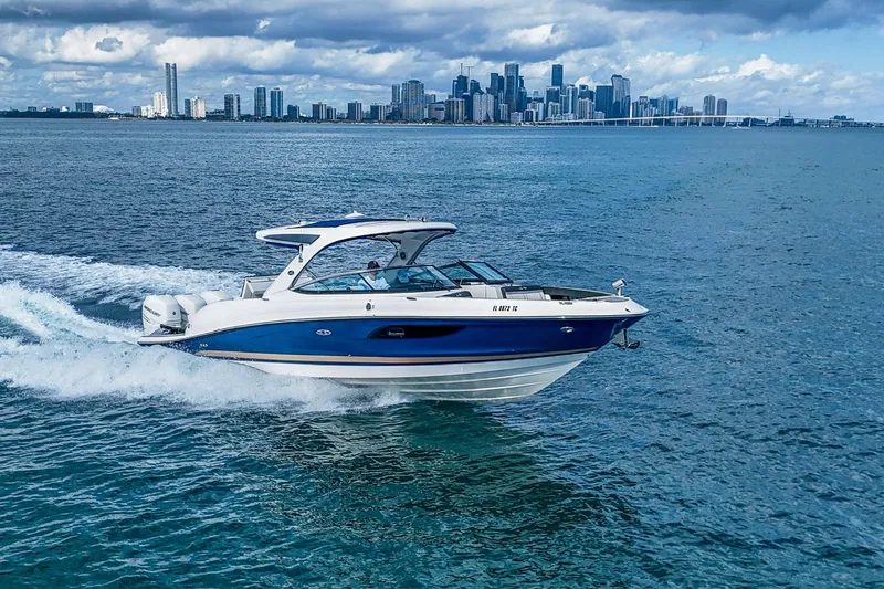 Dock's Knott Inn II Yacht Photos Pics 2018 Sea Ray SLX 350 Outboard cruising on ocean with city skyline in background.