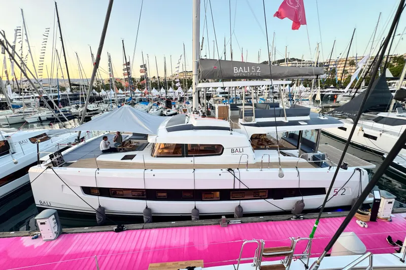 Yacht Photos Pics Luxury Bali 5.2 catamaran yacht docked at marina, 2026 model, vibrant pink dock.