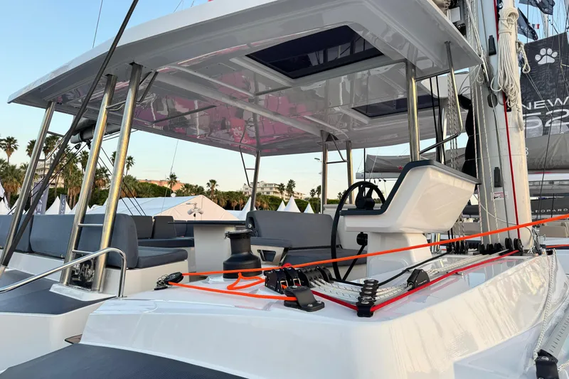  Yacht Photos Pics 2026 Bali 5.2 yacht deck with helm, seating, and rigging in a marina setting.