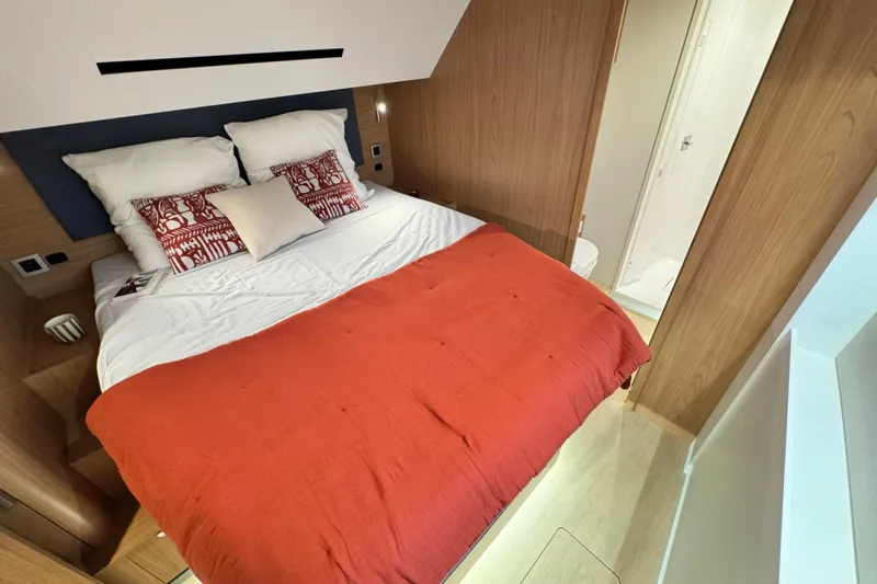  Yacht Photos Pics Luxurious bedroom in 2026 Bali 5.2 yacht with red bedding and modern design.