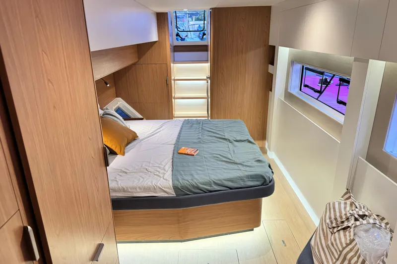  Yacht Photos Pics Modern bedroom interior in 2026 Bali 5.2 yacht, featuring wood accents and cozy bedding.