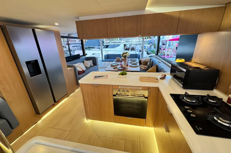  Yacht Photos Pics Modern kitchen interior on a 2026 Bali 5.2 yacht, featuring sleek appliances and elegant dining area.