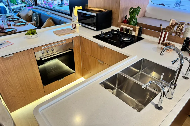  Yacht Photos Pics Modern kitchen in 2026 Bali 5.2 yacht with dual sinks, stove, and oven.