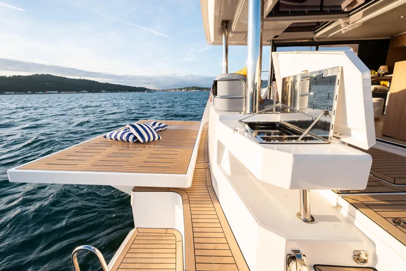  Yacht Photos Pics Luxurious 2026 Bali 5.2 yacht deck with outdoor kitchen and scenic ocean view.