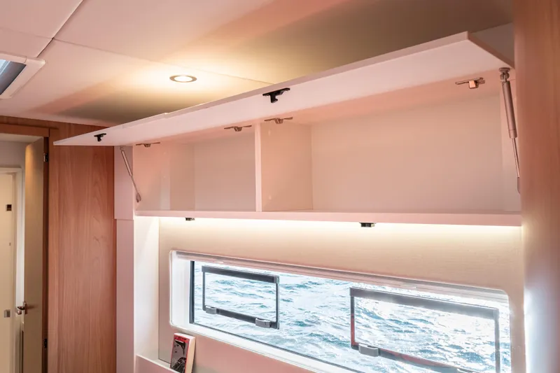  Yacht Photos Pics Interior of Bali 5.2 (2026) yacht with open storage and ocean view window.