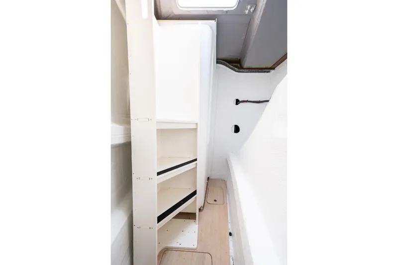  Yacht Photos Pics Interior of 2026 Bali 5.2 yacht with shelving and wooden flooring.