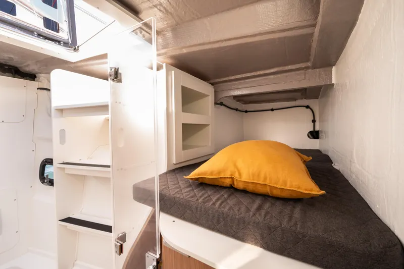  Yacht Photos Pics Cozy cabin interior of 2026 Bali 5.2 yacht with bed and storage.