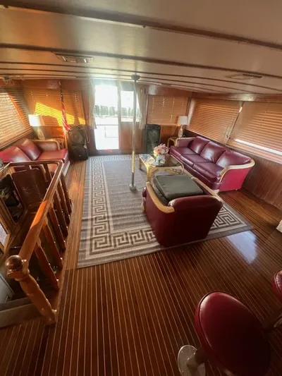 Majestic Yacht Photos Pics Luxurious interior of 1987 Marine Trader 62 Med Yacht with wooden flooring and leather seating.