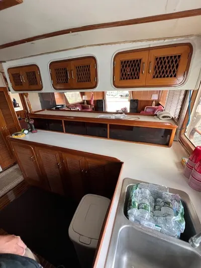 Majestic Yacht Photos Pics Interior of 1987 Marine Trader 62 Med Yacht with wooden cabinets and countertop.