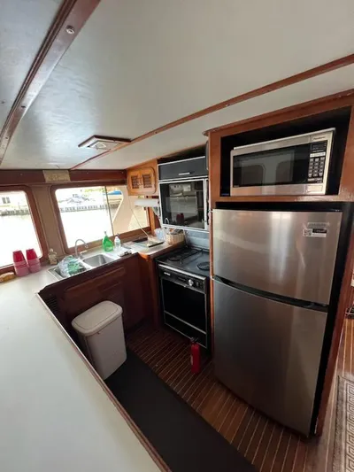 Majestic Yacht Photos Pics 1987 Marine Trader 62 Med Yacht kitchen with modern appliances and wood finish.