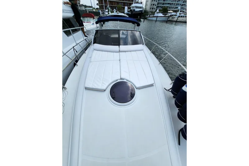  Yacht Photos Pics 2004 Pershing 37 yacht with sunbathing deck, docked in marina.