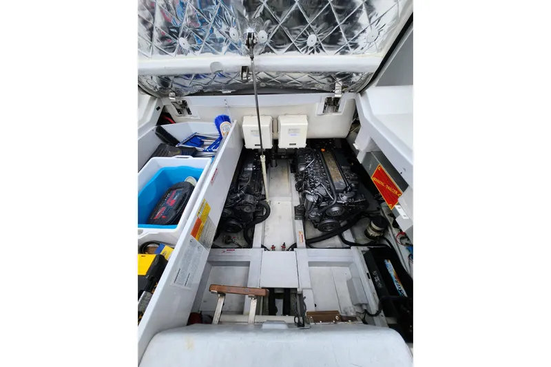  Yacht Photos Pics Engine compartment of a 2004 Pershing 37 yacht, showcasing dual engines and storage areas.