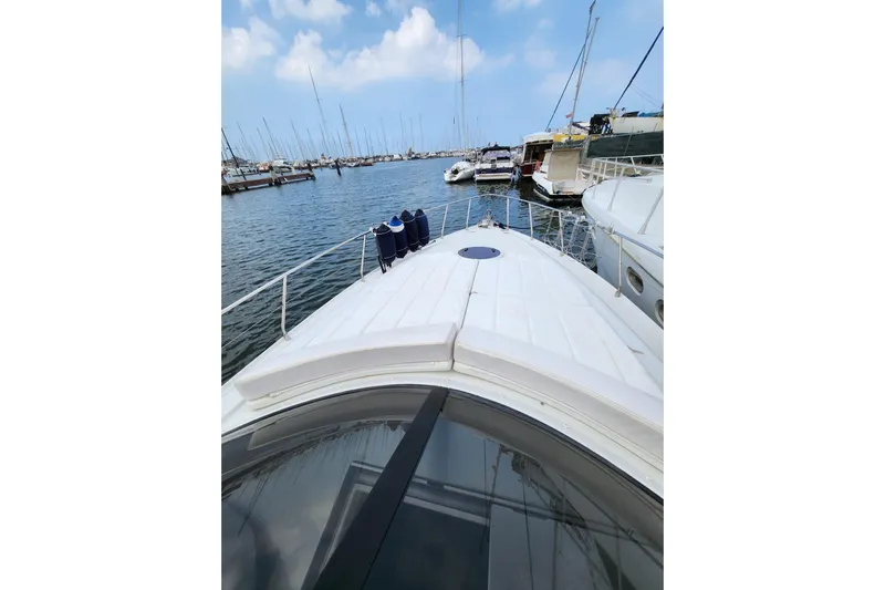  Yacht Photos Pics 2004 Pershing 37 yacht docked in a marina under a clear blue sky.