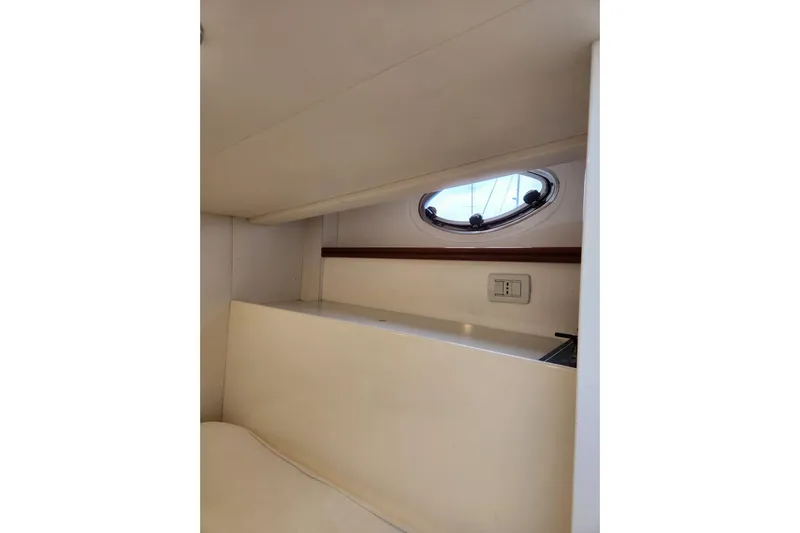  Yacht Photos Pics Interior cabin of 2004 Pershing 37 yacht with porthole and light switch.