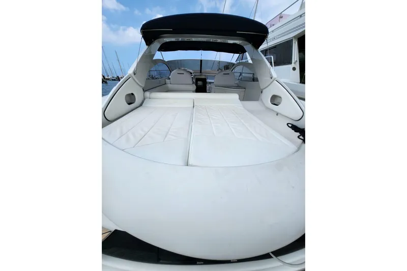  Yacht Photos Pics 2004 Pershing 37 yacht with spacious white deck and seating area.