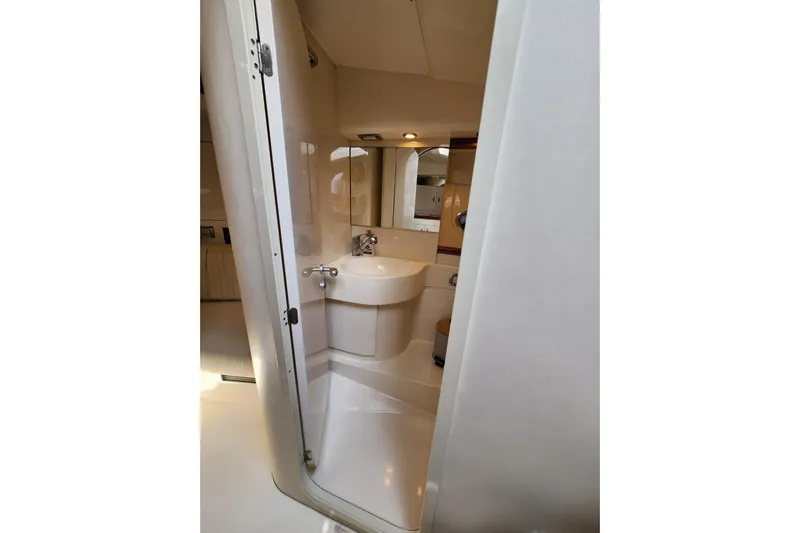  Yacht Photos Pics Bathroom interior of 2004 Pershing 37 yacht, featuring compact sink and mirror.