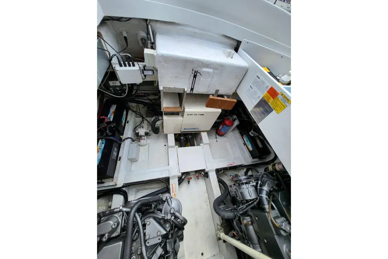  Yacht Photos Pics Engine compartment of a 2004 Pershing 37 yacht, showcasing mechanical components and wiring.