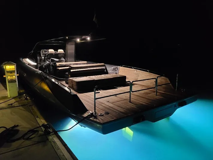  Yacht Photos Pics Luxury Anvera 55 yacht docked at night, illuminated by underwater lights.