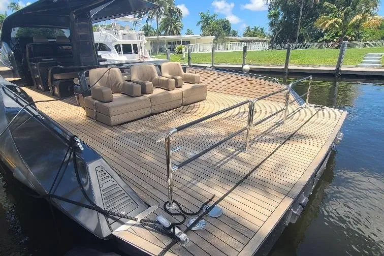  Yacht Photos Pics Luxury Anvera 55 yacht deck with seating, docked by a waterfront, 2016 model.