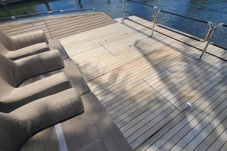  Yacht Photos Pics Luxury Anvera 55 yacht deck with beige lounge chairs, 2016 model, by the water.