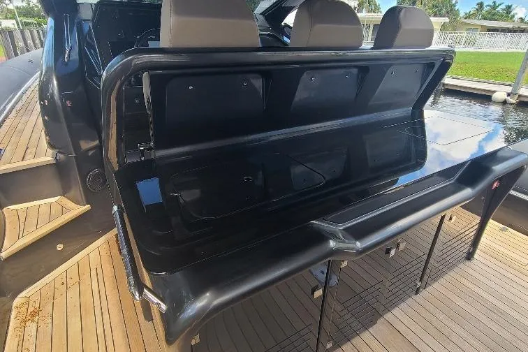  Yacht Photos Pics Anvera 55 yacht interior, 2016 model, featuring sleek black seating and wooden deck.