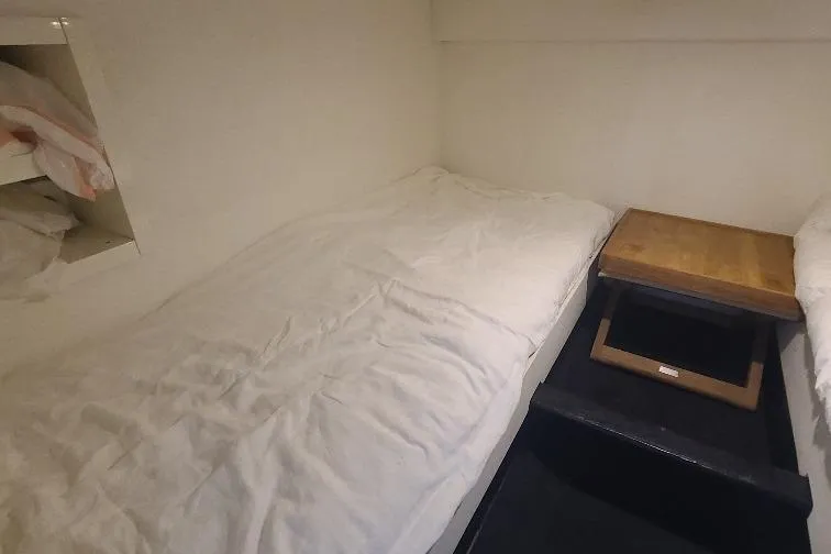  Yacht Photos Pics Cozy cabin interior of 2016 Anvera 55 yacht with twin beds and wooden table.