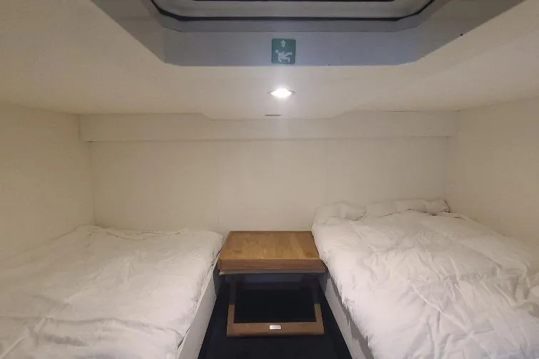  Yacht Photos Pics Cozy cabin interior of 2016 Anvera 55 yacht with twin beds and wooden table.