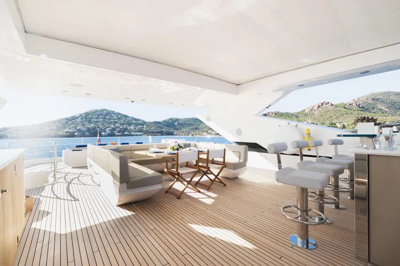 King Power Yacht Photos Pics Luxurious Sunseeker 116 Yacht 2016 with elegant deck, bar stools, and scenic ocean view.