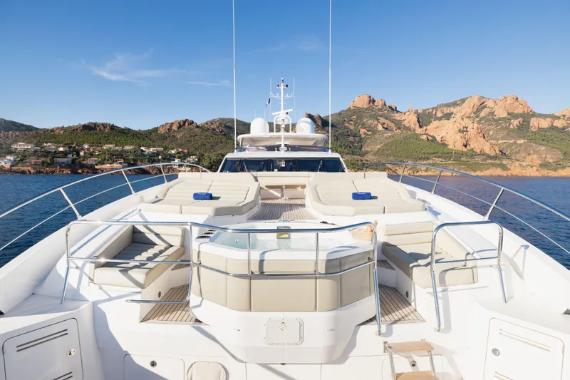 King Power Yacht Photos Pics Luxurious 2016 Sunseeker 116 Yacht with sun loungers and jacuzzi, scenic coastal backdrop.