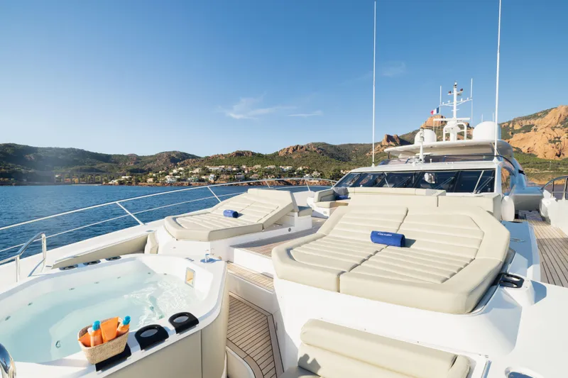 King Power Yacht Photos Pics Luxurious 2016 Sunseeker 116 Yacht with sunbeds and jacuzzi, cruising near scenic coastline.