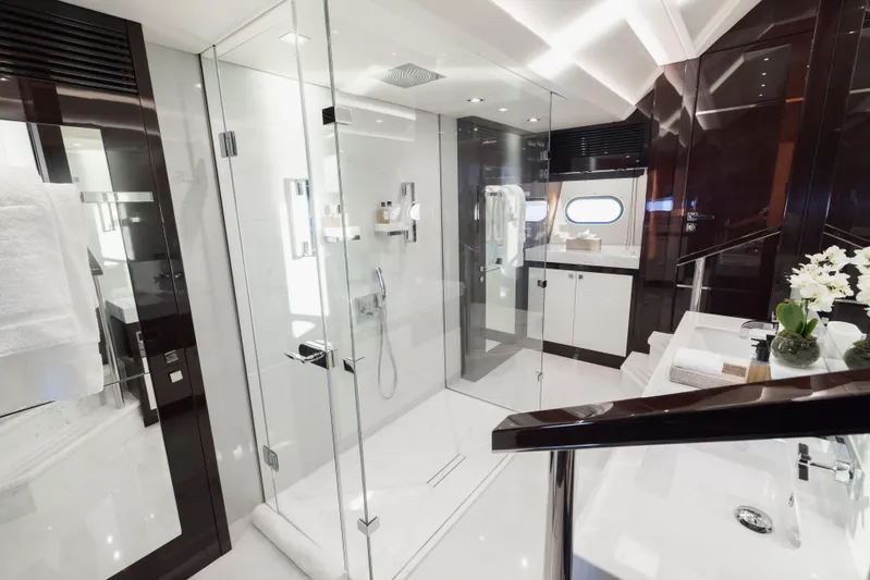 King Power Yacht Photos Pics Luxurious bathroom on 2016 Sunseeker 116 Yacht with glass shower and elegant fixtures.
