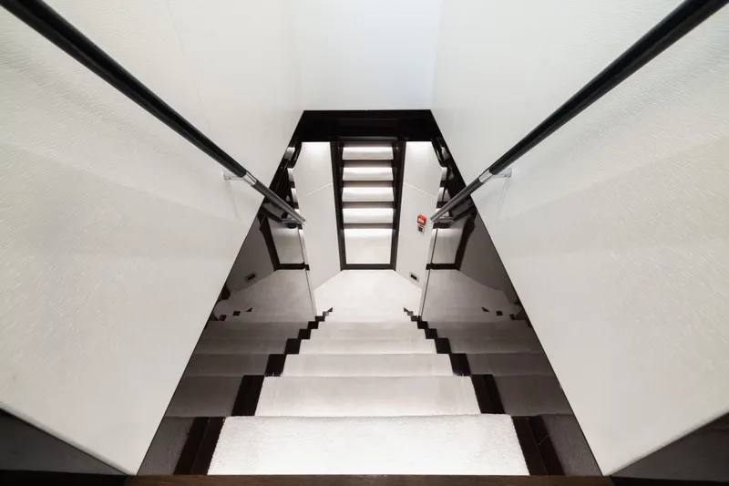 King Power Yacht Photos Pics Staircase interior of 2016 Sunseeker 116 Yacht, featuring sleek modern design.