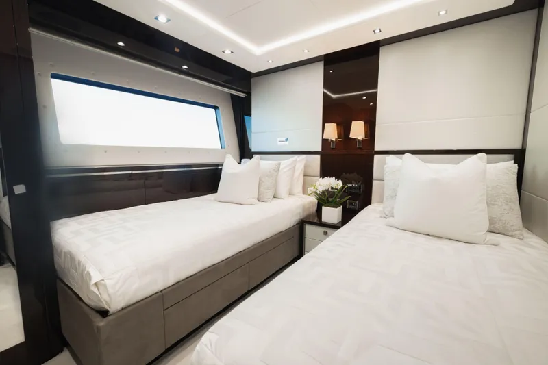King Power Yacht Photos Pics Luxurious twin bedroom on 2016 Sunseeker 116 Yacht, featuring elegant decor and modern lighting.