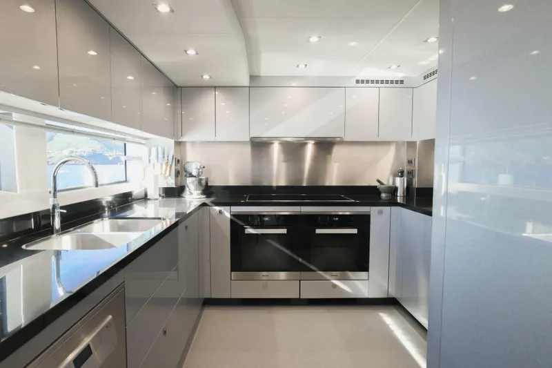 King Power Yacht Photos Pics Luxurious kitchen interior of 2016 Sunseeker 116 Yacht with modern appliances and sleek design.