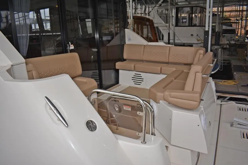 Yacht Photos Pics 2017 Sea Ray Sundancer 460 yacht with beige seating in a marina setting.