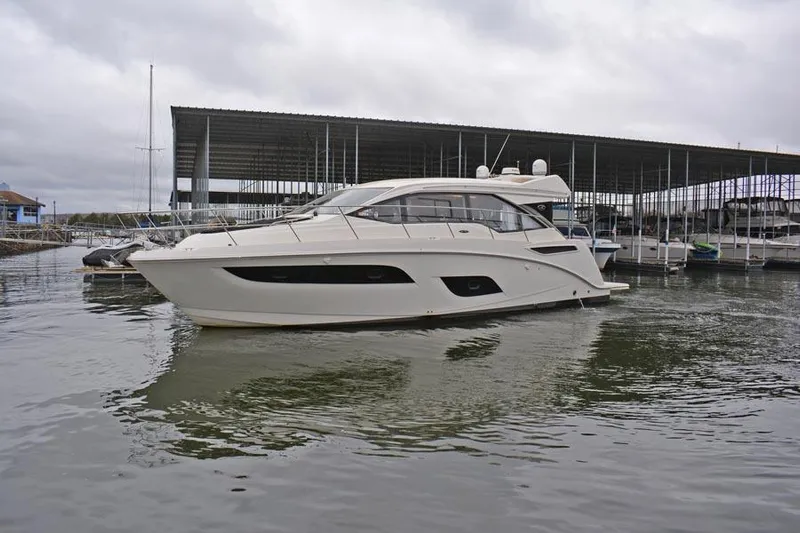  Yacht Photos Pics 2017 Sea Ray Sundancer 460 yacht docked in a marina under cloudy skies.