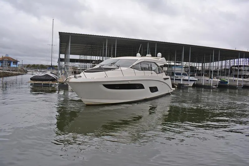  Yacht Photos Pics 2017 Sea Ray Sundancer 460 yacht docked at marina under cloudy skies.
