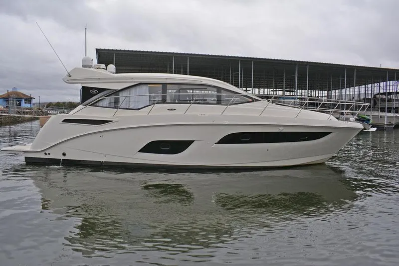  Yacht Photos Pics 2017 Sea Ray Sundancer 460 yacht docked in a marina, side view.