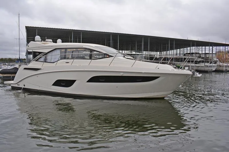  Yacht Photos Pics 2017 Sea Ray Sundancer 460 yacht docked at marina under cloudy skies.