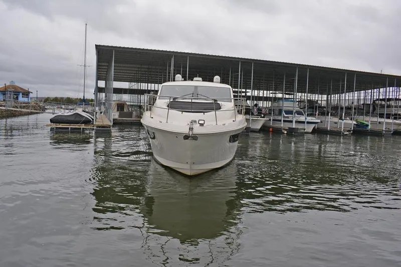  Yacht Photos Pics 2017 Sea Ray Sundancer 460 yacht docked at marina under cloudy skies.