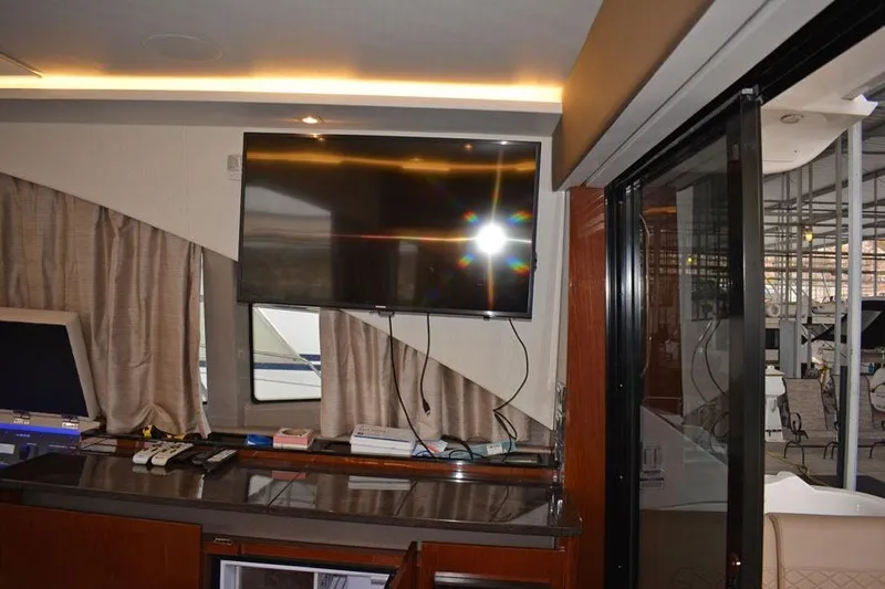 Yacht Photos Pics Interior of 2017 Sea Ray Sundancer 460 yacht with TV and sliding glass door.