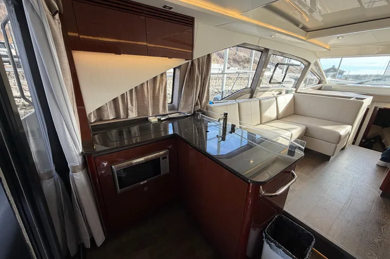  Yacht Photos Pics Luxurious interior of 2017 Sea Ray Sundancer 460 yacht with modern kitchen and seating area.