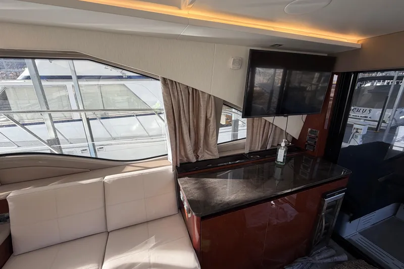  Yacht Photos Pics Interior of 2017 Sea Ray Sundancer 460 yacht with sofa, TV, and countertop.