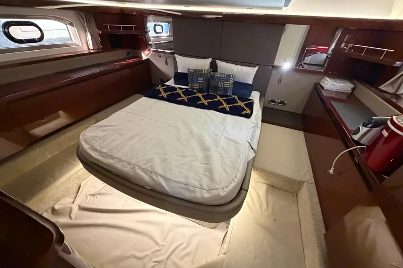  Yacht Photos Pics Luxurious cabin interior of 2017 Sea Ray Sundancer 460 yacht with cozy bed and elegant decor.