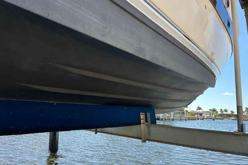  Yacht Photos Pics 2014 Sea Ray 370 Venture boat hull on lift, with waterfront view.