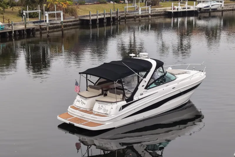  Yacht Photos Pics 2014 Sea Ray 370 Venture boat on calm water, featuring sleek design and American flag.