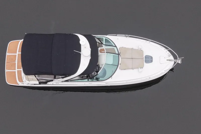  Yacht Photos Pics 2014 Sea Ray 370 Venture boat, aerial view, sleek design, black canopy, wooden deck.